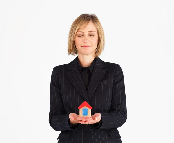 Cute mature businesswoman holding a house — Stock Photo, Image