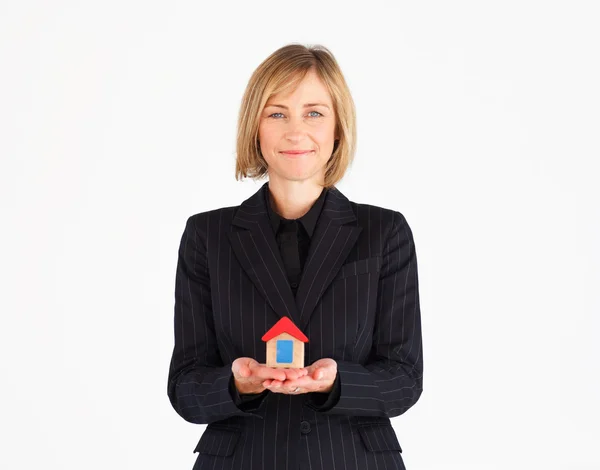 Pretty mature businesswoman holding a house — Stock Photo, Image