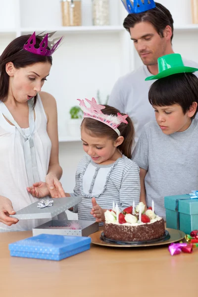 Cute girl unpacking Birthday presents with her family — Stock Photo, Image