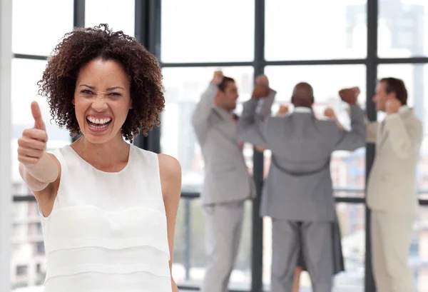 Positive Businesswoman doing a thum-up with his colleagues — Stock Photo, Image