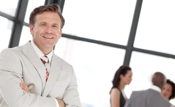 Smiling confident male manager leading his team — Stock Photo, Image