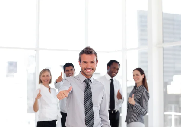 Self-assured business manager standing at the camera with his te — Stock Photo, Image