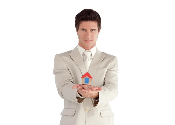 Young businessman presenting a sample of house — Stock Photo, Image