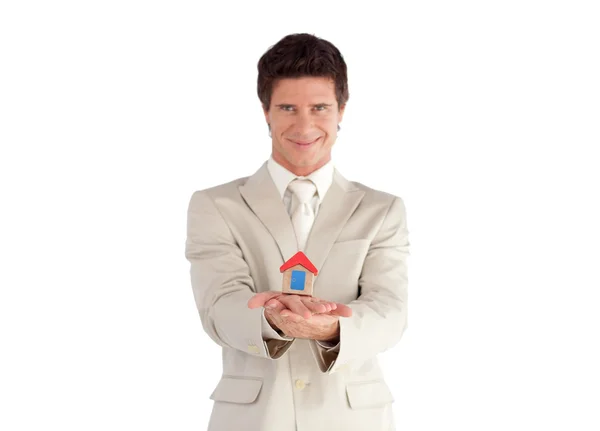 Caucasian young businessman presenting a sample of house — Stock Photo, Image