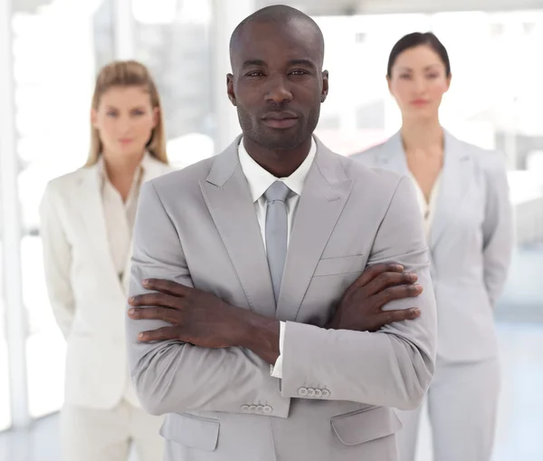 Self-assured afro-american manager with his team — Stock Photo, Image