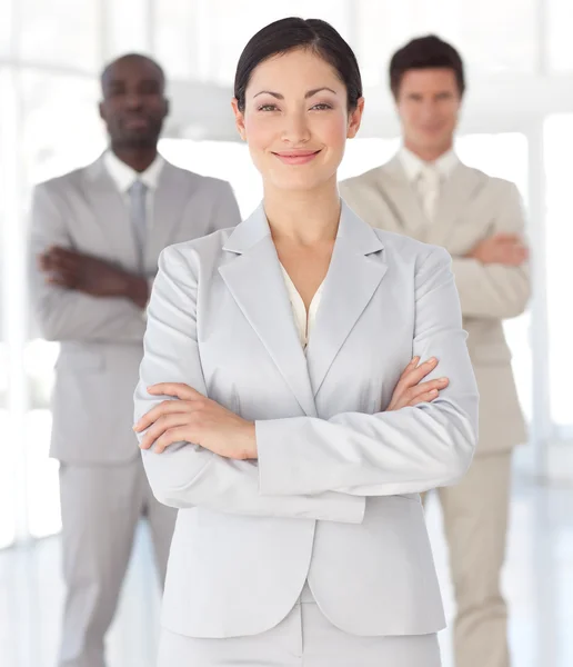 Bright asian businesswoman standing at the camera with arms fold — Stock Photo, Image