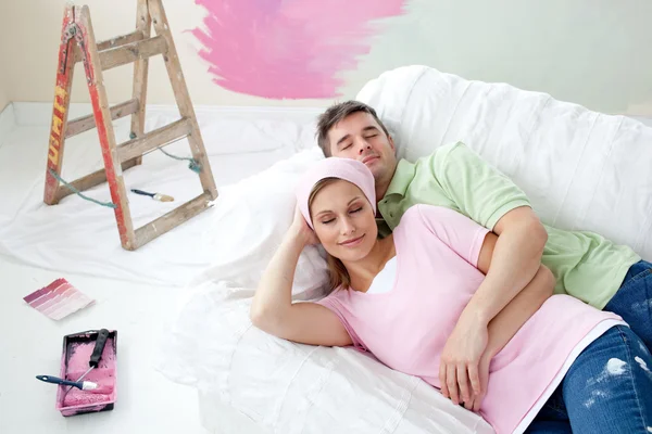 Relaxing couple lying on a sofa — Stock Photo, Image
