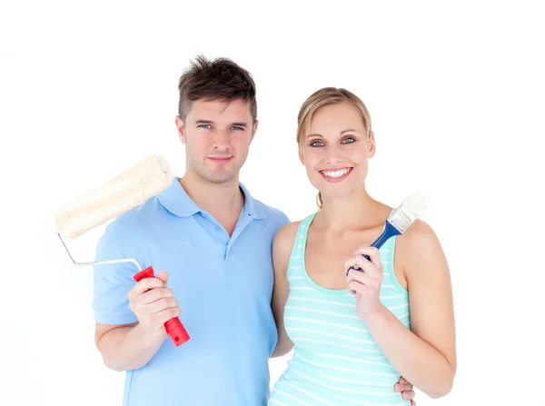 Loving couple painting in their new house — Stock Photo, Image