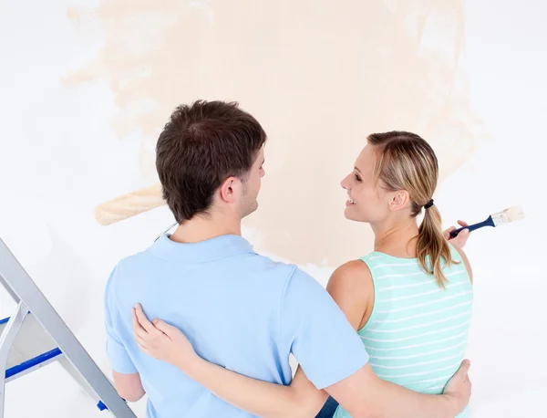 Affectionate couple painting a room — Stock Photo, Image