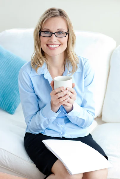 Charismatic businesswoman holding cup wearing glasses — Stock Photo, Image