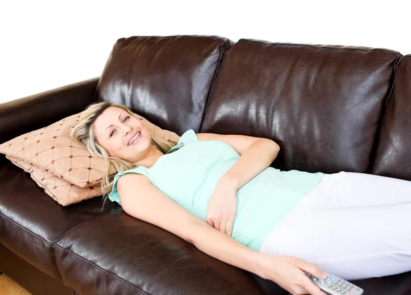 Mulher sem estresse encontra-se no sofá e assiste TV — Fotografia de Stock