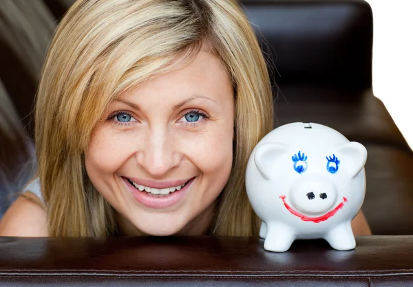 Portrait of a handsome woman with a piggybank — Stock Photo, Image