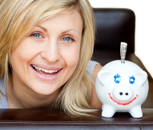 Laughing woman with a piggy bank — Stock Photo, Image