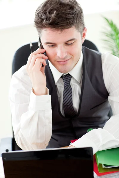 Confident young businessman talking on phone — Stock Photo, Image