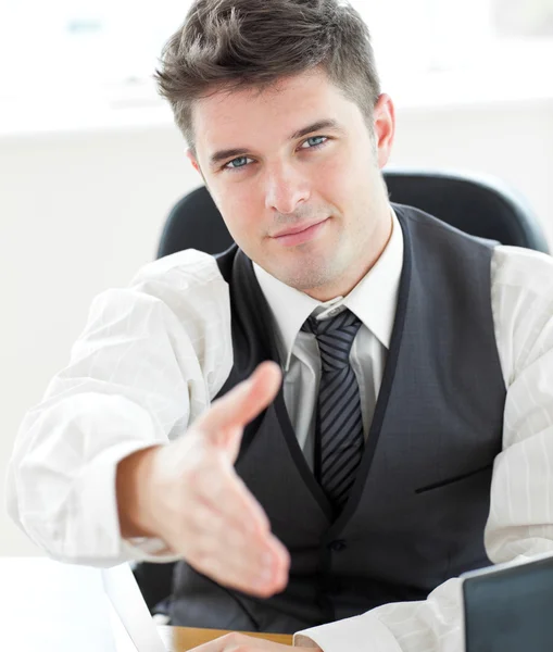 Charming young businessman holding out his hand — Stock Photo, Image
