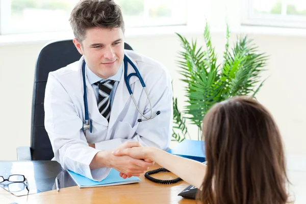 Delighted male doctor welcome his patient — Stock Photo, Image