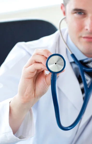 Male doctor holding a stethoscope — Stock Photo, Image
