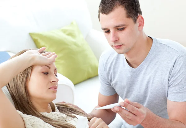 Cuidar hombre comprobar la temperatura de su novia enferma con una t —  Fotos de Stock