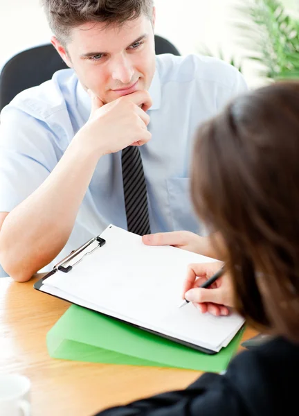 Young salesman looking at female customer sign a contract — Stock Photo, Image