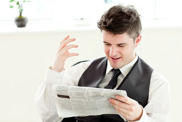 Portrait of a positive businessman reading a newspaper siiting i — Stock Photo, Image