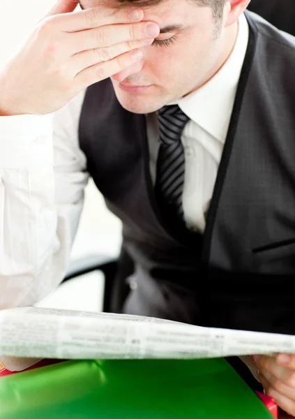 Thinking businessman reading a newspaper — Stock Photo, Image