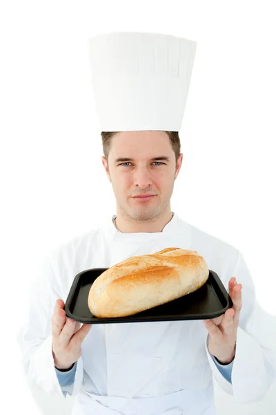 Um cozinheiro masculino segurando pão olhando para a câmera contra branco — Fotografia de Stock