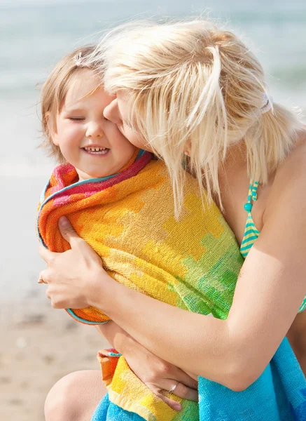 A portrait of a mother kissing her laughing daughter — Stock Photo, Image