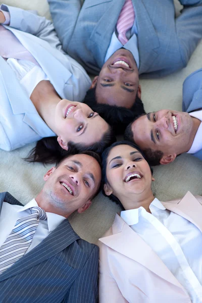 Business team on floor in a circle — Stock Photo, Image