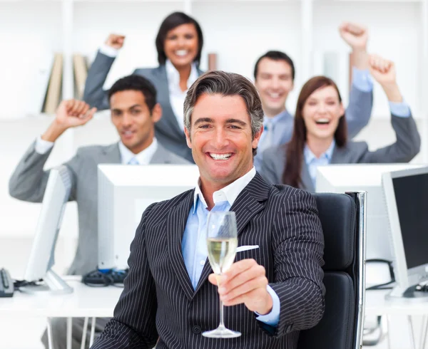 Triumphant manager and his team drinking champagne — Stock Photo, Image