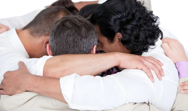 Confident business team hugging each other in a circle — Stock Photo, Image