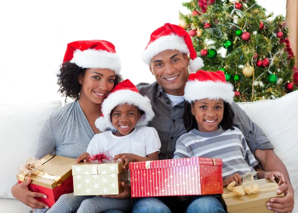 Afro-American family holding Christmas presents — Stock Photo, Image