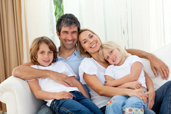 Aile kanepede rahatlatıcı gülümseyen — Stok fotoğraf