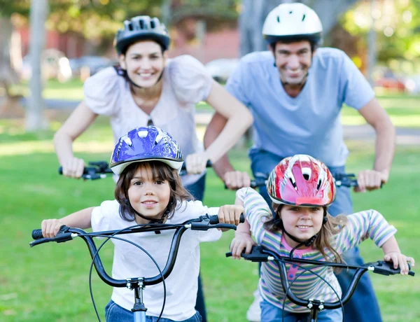 Happy family riding a bike — Stock Photo, Image