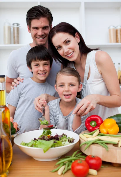 Smiling family cooking together — Stock Photo, Image