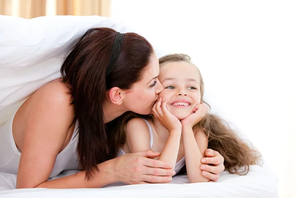 Attentive mother kissing her daughter — Stock Photo, Image