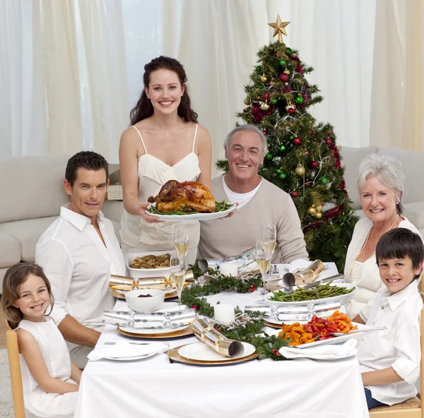 Family celebrating Christmas dinner with turkey — Stock Photo, Image