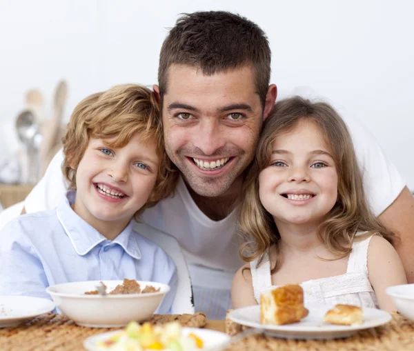 Portrait of children having breakfast with their father — Stock Photo, Image