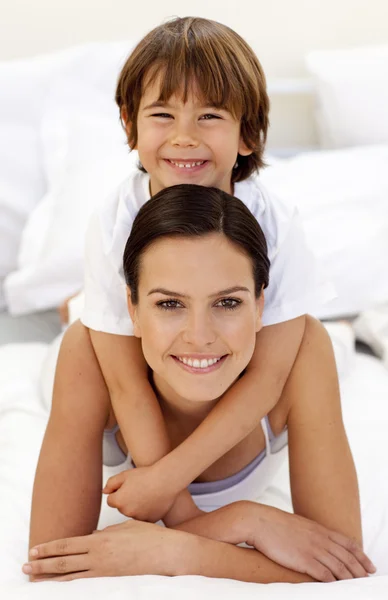 Son hugging his mother in bed — Stock Photo, Image