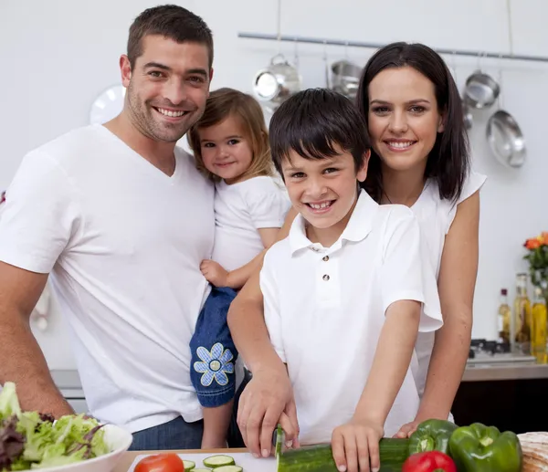 Affectionate young family cooking together — Stock Photo, Image