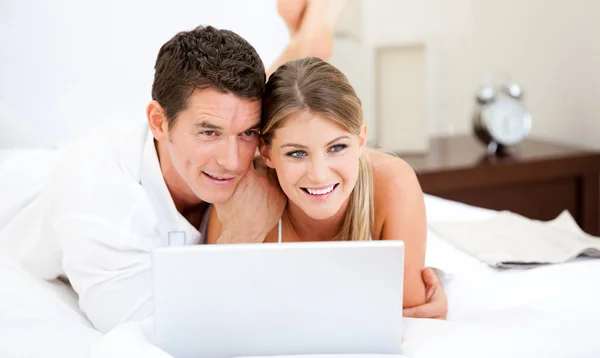 Positive couple surfing on the internet — Stock Photo, Image