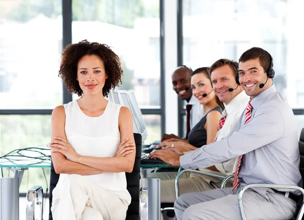 Multi-ethnic business team in a call center — Stock Photo, Image