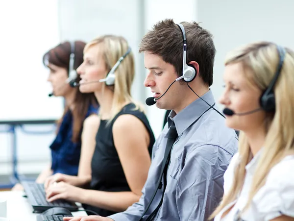 Attractive young man working in a call center — Stock Photo, Image