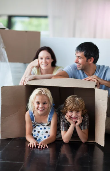Happy family playing at home with boxes — Stock Photo, Image