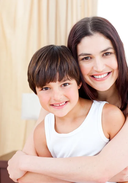 Smiling mother hugging her son — Stock Photo, Image