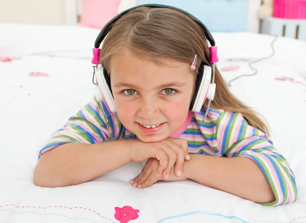 Smiling little gril listening to music — Stock Photo, Image