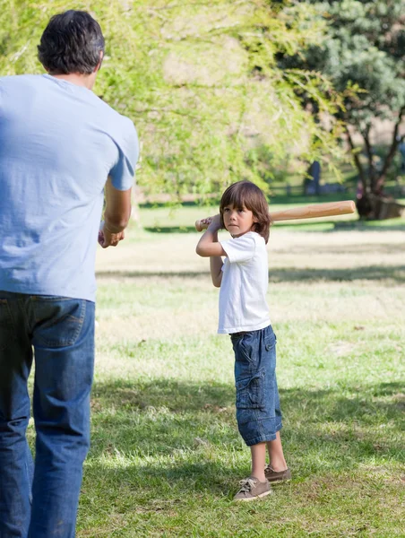 Jolly little boy playing baseball with his father — Stock Photo, Image