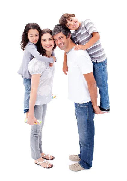 Affectionate parents giving their children a piggyback ride — Stock Photo, Image