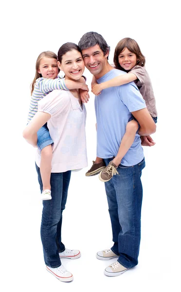Jolly parents giving their children a piggyback ride — Stock Photo, Image