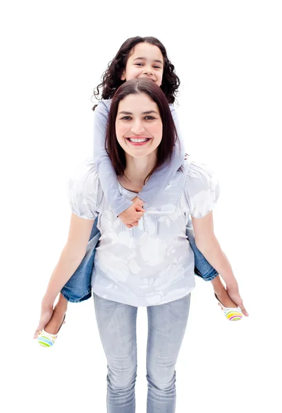 Attractive mother giving her daughter a piggyback ride — Stock Photo, Image