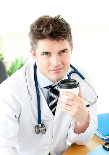 Charismatic surgeon having a break in the staff room — Stock Photo, Image